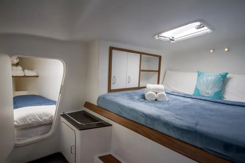 Moonstruck Yacht Photos Pics Luxurious cabin interior of 2018 Voyage Yachts VOYAGE 480 with cozy bedding and modern amenities.