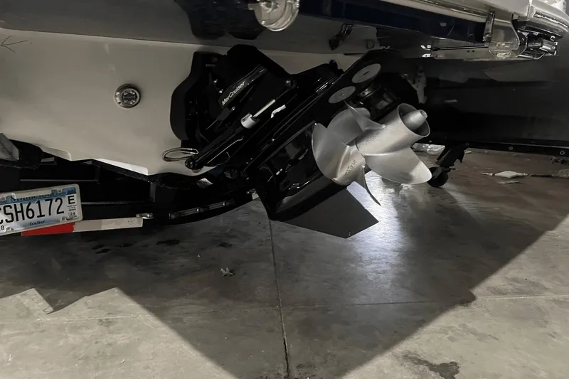  Yacht Photos Pics 2024 Sea Ray SDX 290 boat propeller and stern drive in a garage setting.