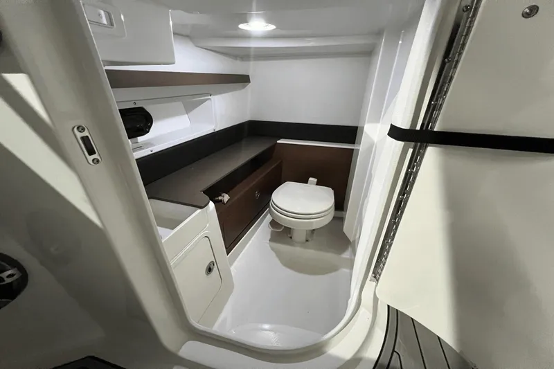  Yacht Photos Pics 2024 Sea Ray SDX 290 boat interior bathroom with modern amenities and sleek design.