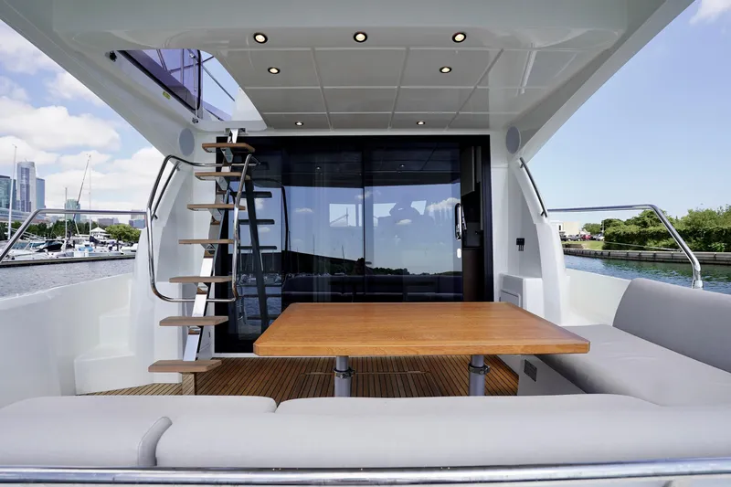  Yacht Photos Pics Prestige 460 yacht interior, 2023 model, featuring a modern seating area and staircase.