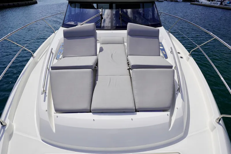  Yacht Photos Pics 2023 Prestige 460 yacht with luxurious sunbathing cushions on deck.