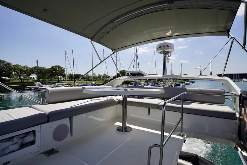  Yacht Photos Pics 2023 Prestige 460 yacht interior with seating area and marina view.