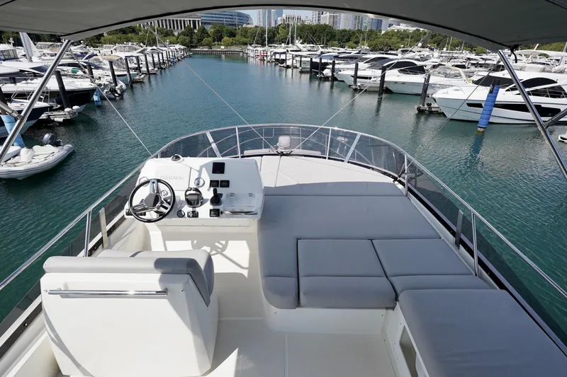  Yacht Photos Pics Flybridge view of 2023 Prestige 460 yacht docked in a marina.