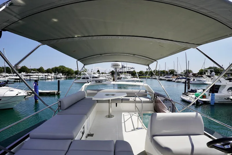  Yacht Photos Pics 2023 Prestige 460 yacht interior with spacious seating, docked in a marina.