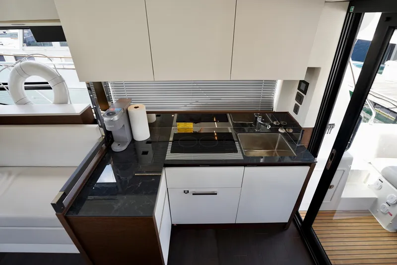  Yacht Photos Pics Modern kitchen interior on 2023 Prestige 460 yacht, featuring sleek countertops and appliances.