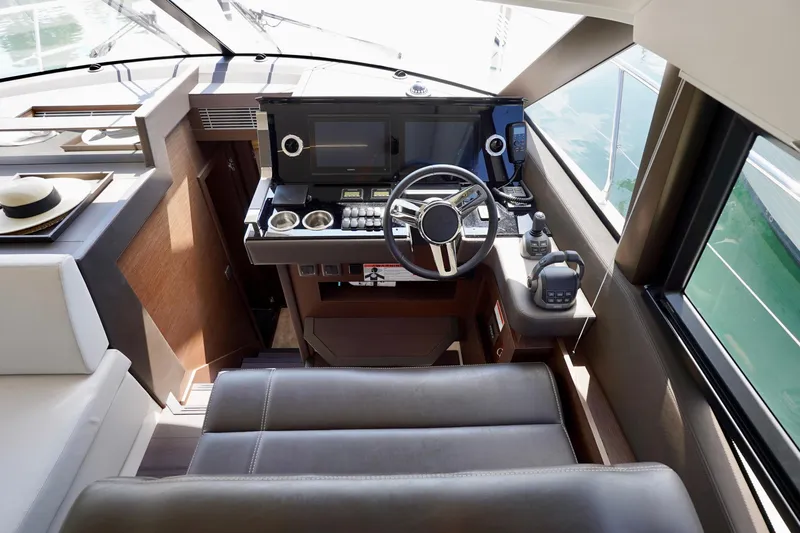  Yacht Photos Pics Luxurious 2023 Prestige 460 yacht helm with modern controls and leather seating.