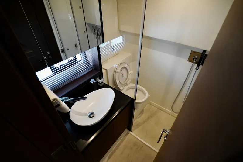  Yacht Photos Pics Modern bathroom interior on 2023 Prestige 460 yacht, featuring sleek sink and shower.