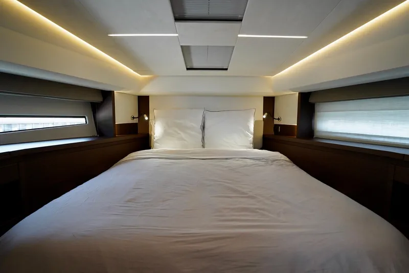  Yacht Photos Pics Luxurious bedroom interior of 2023 Prestige 460 yacht with modern lighting and cozy bedding.