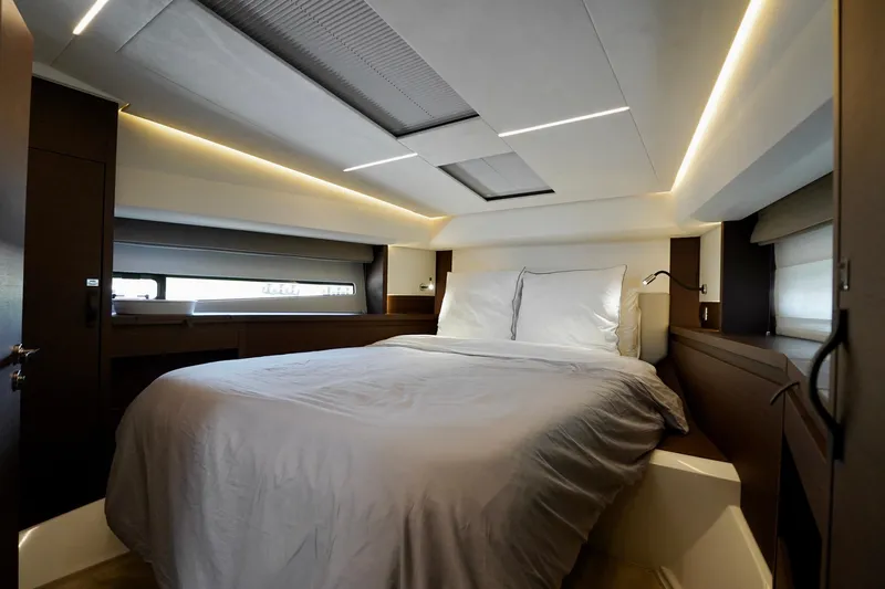  Yacht Photos Pics Luxurious bedroom interior of 2023 Prestige 460 yacht with modern lighting and elegant design.
