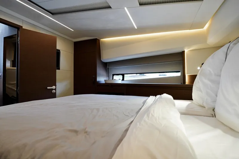  Yacht Photos Pics Luxurious bedroom interior of 2023 Prestige 460 yacht with modern design and ambient lighting.