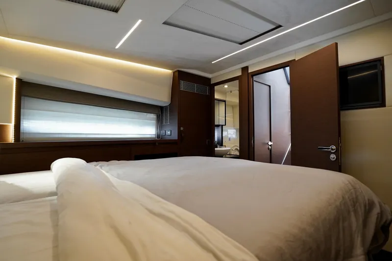 Yacht Photos Pics Luxurious bedroom interior of 2023 Prestige 460 yacht, featuring modern design and ambient lighting.