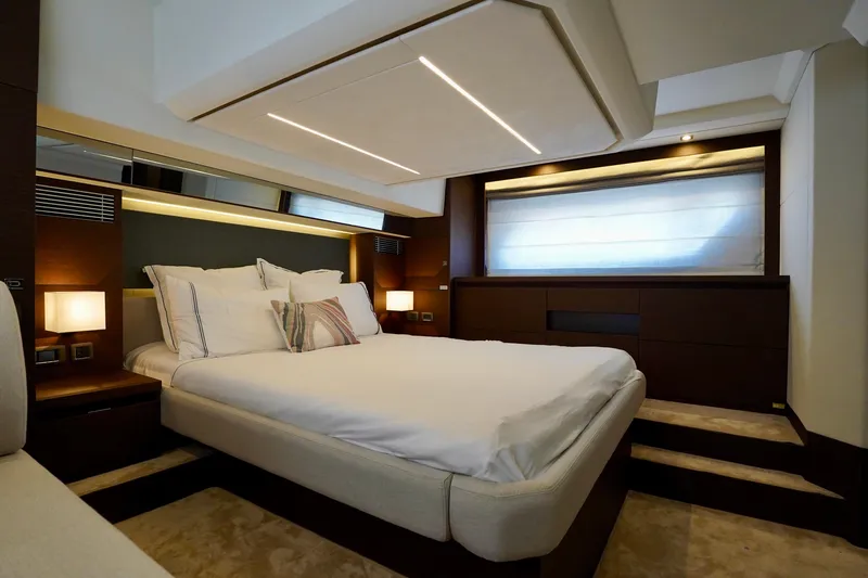  Yacht Photos Pics Luxurious bedroom interior of 2023 Prestige 460 yacht with modern design and ambient lighting.