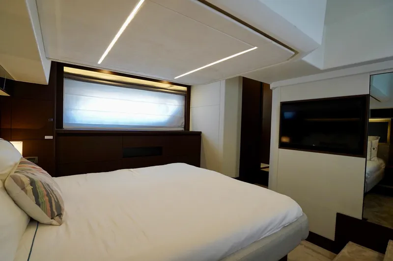  Yacht Photos Pics Luxurious bedroom interior of 2023 Prestige 460 yacht with modern design and ambient lighting.