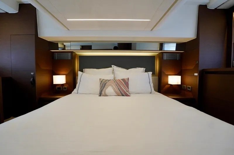  Yacht Photos Pics Luxurious bedroom interior of 2023 Prestige 460 yacht with modern lighting and elegant decor.