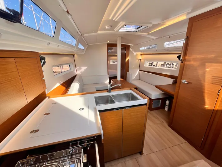  Yacht Photos Pics Interior of 2024 Jeanneau 380 yacht, featuring modern kitchen and seating area.