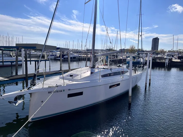  Yacht Photos Pics 2024 Jeanneau 380 sailboat docked in a marina under a clear blue sky.
