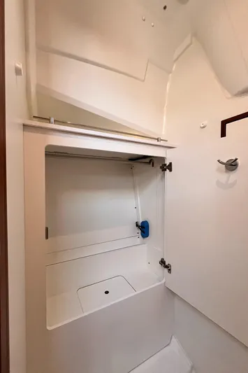 Yacht Photos Pics 2024 Jeanneau 380 interior storage compartment with white finish and modern design.