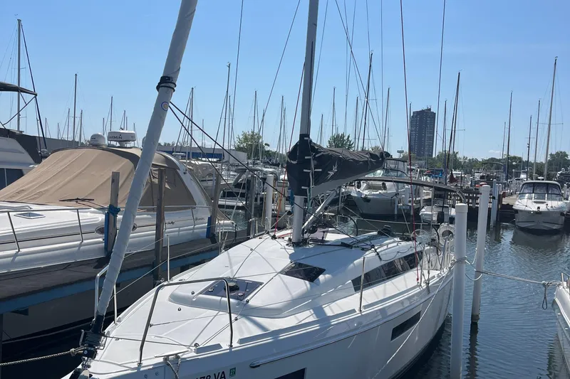  Yacht Photos Pics 2024 Jeanneau 380 sailboat docked in a marina under clear blue skies.