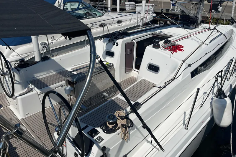  Yacht Photos Pics 2024 Jeanneau 380 sailboat cockpit with dual steering wheels and modern design.
