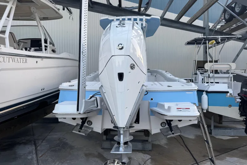 Your Next Boat! Yacht Photos Pics 2026 Blackfin 242 HB boat with powerful outboard motor in a marina setting.