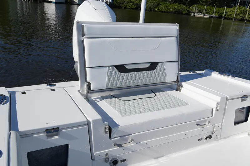 Your Next Boat! Yacht Photos Pics 2026 Blackfin 242 HB boat with white cushioned seating and storage compartments.