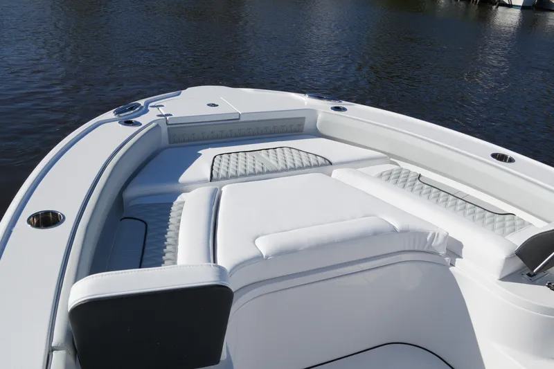 Your Next Boat! Yacht Photos Pics 2026 Blackfin 242 HB boat interior with cushioned seating on calm water.