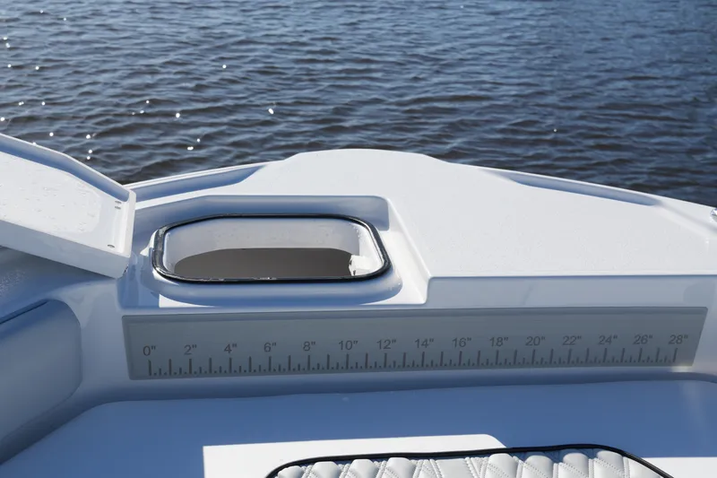 Your Next Boat! Yacht Photos Pics 2026 Blackfin 242 HB boat with open hatch and ruler, on calm water.