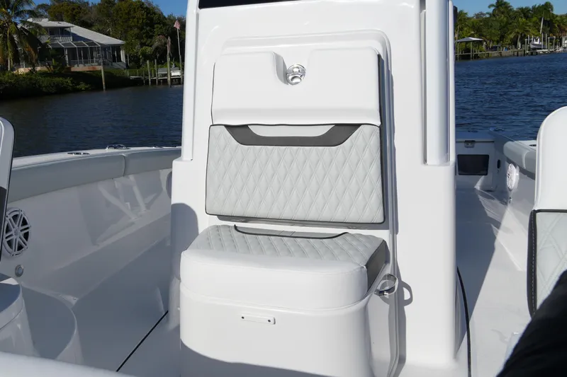 Your Next Boat! Yacht Photos Pics 2026 Blackfin 242 HB boat interior with quilted seating, docked by a scenic waterfront.