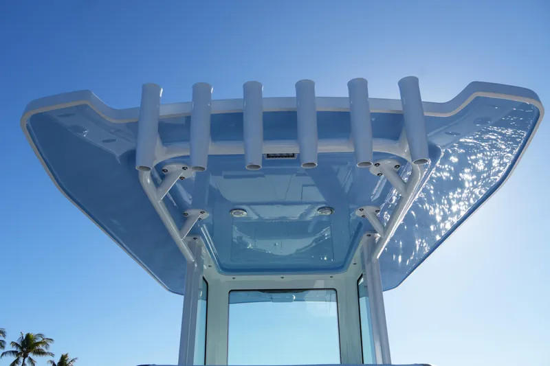 Your Next Boat! Yacht Photos Pics 2026 Blackfin 242 HB boat top view with rod holders against clear blue sky.