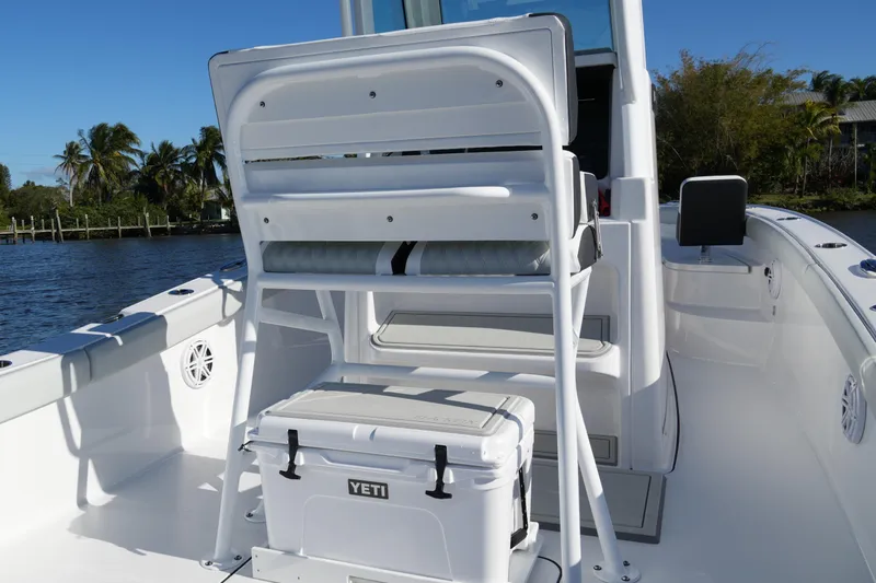 Your Next Boat! Yacht Photos Pics 2026 Blackfin 242 HB boat interior with seating and Yeti cooler on a sunny day.