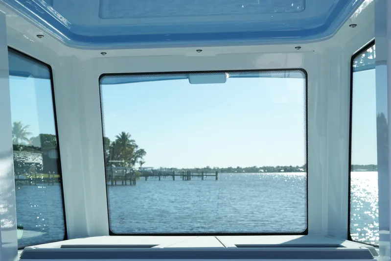Your Next Boat! Yacht Photos Pics View from 2026 Blackfin 242 HB boat cabin overlooking serene waterfront and docks.