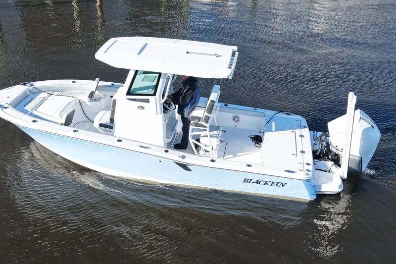 Your Next Boat! Yacht Photos Pics 2026 Blackfin 242 HB boat cruising on calm water, side view.