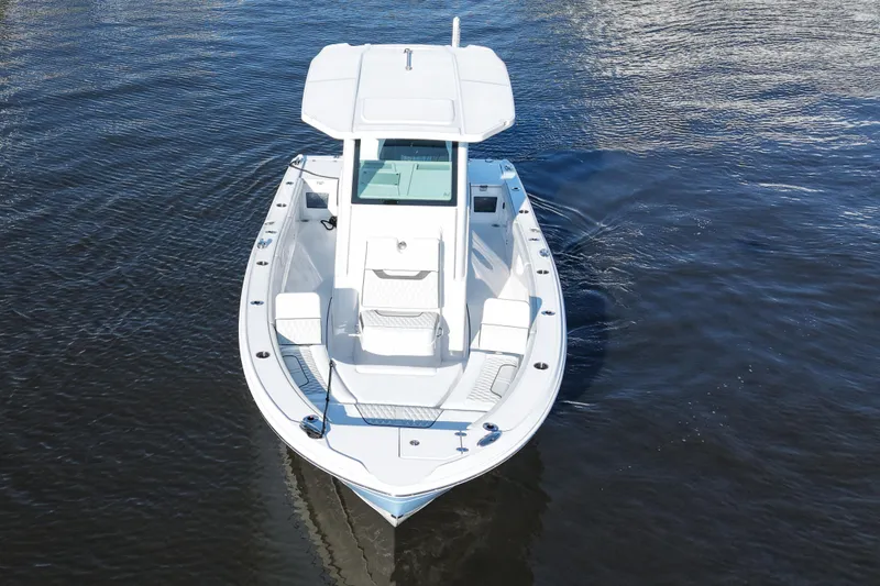 Your Next Boat! Yacht Photos Pics 2026 Blackfin 242 HB boat cruising on calm water, aerial view.