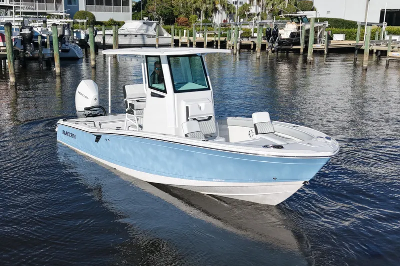 Your Next Boat! Yacht Photos Pics 2026 Blackfin 242 HB boat in marina, light blue hull, calm water, sunny day.