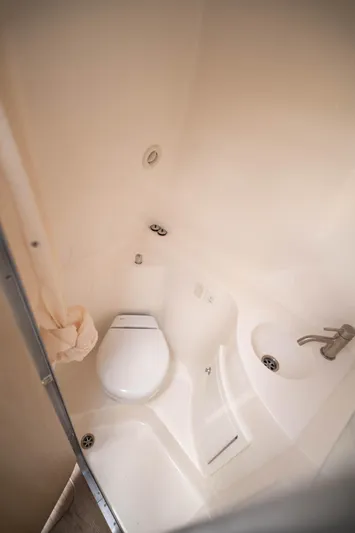  Yacht Photos Pics 2023 Regal 26 XO boat bathroom with toilet and sink, compact and modern design.