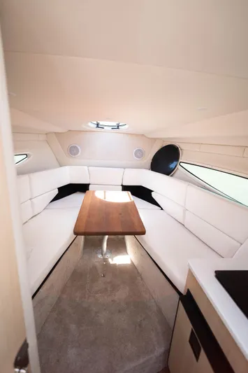  Yacht Photos Pics 2023 Regal 26 XO cabin interior with white seating and wooden table.