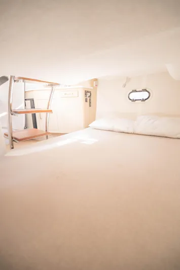  Yacht Photos Pics 2023 Regal 26 XO cabin interior with bed and porthole window.