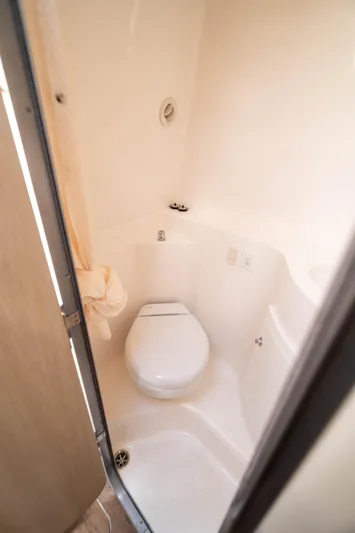  Yacht Photos Pics 2023 Regal 26 XO boat bathroom with compact toilet and white interior.