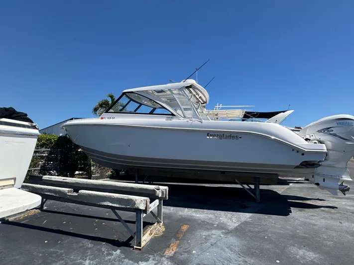  Yacht Photos Pics 2019 Everglades 340 Dual Console boat on a trailer under clear blue sky.