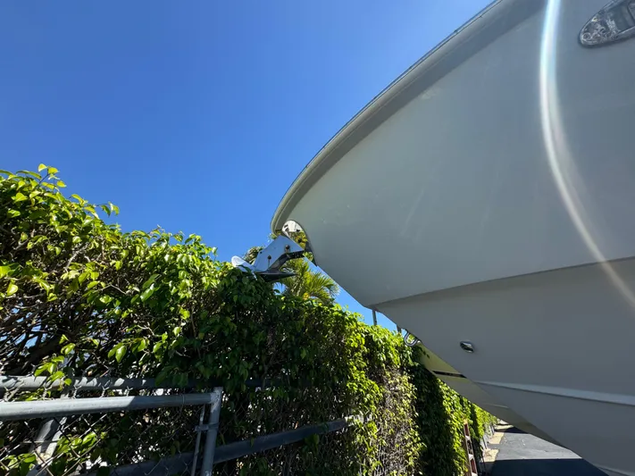 Yacht Photos Pics 2019 Everglades 340 Dual Console boat near green foliage under clear blue sky.