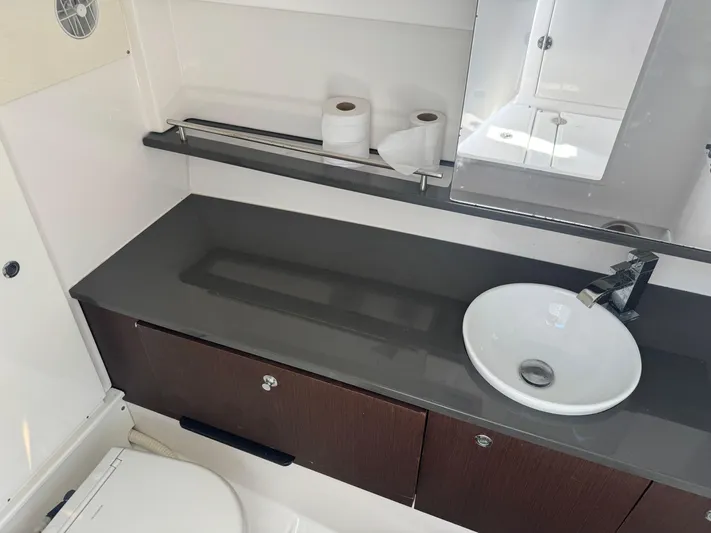  Yacht Photos Pics Bathroom interior of 2019 Everglades 340 Dual Console boat with sink and storage.