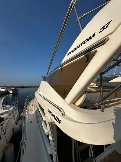  Yacht Photos Pics 1997 Fairline Phantom 37 yacht docked at marina under clear blue sky.