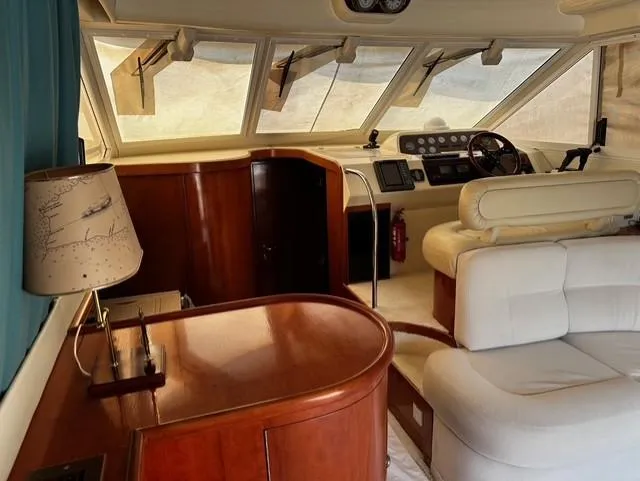  Yacht Photos Pics Interior of 1997 Fairline Phantom 37 yacht with wooden cabinetry and white seating.