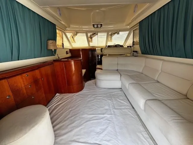  Yacht Photos Pics Luxurious interior of a 1997 Fairline Phantom 37 yacht with white seating and wooden cabinetry.