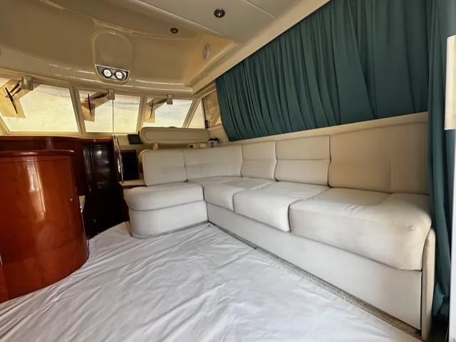  Yacht Photos Pics Luxurious interior of 1997 Fairline Phantom 37 yacht with white sofa and wooden accents.