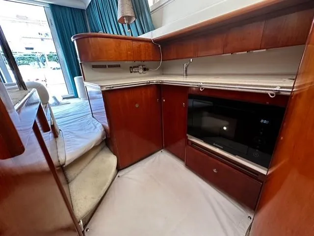  Yacht Photos Pics Interior of 1997 Fairline Phantom 37 yacht with wooden cabinetry and modern appliances.