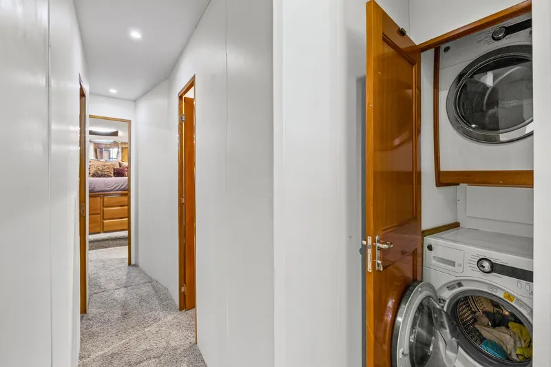  Yacht Photos Pics Hallway in 1998 Viking 72 Enclosed Bridge yacht with laundry area and bedroom view.