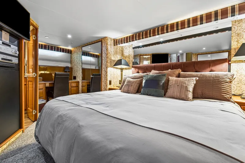  Yacht Photos Pics Luxurious bedroom interior of 1998 Viking 72 Enclosed Bridge yacht with elegant decor.