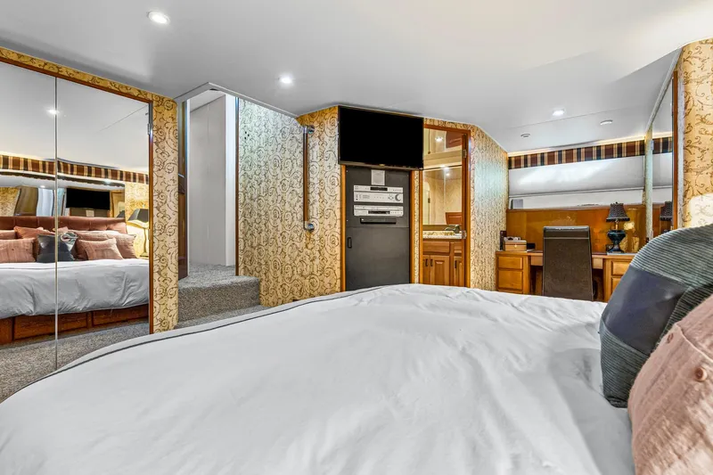  Yacht Photos Pics Luxurious bedroom interior of 1998 Viking 72 Enclosed Bridge yacht with elegant decor.