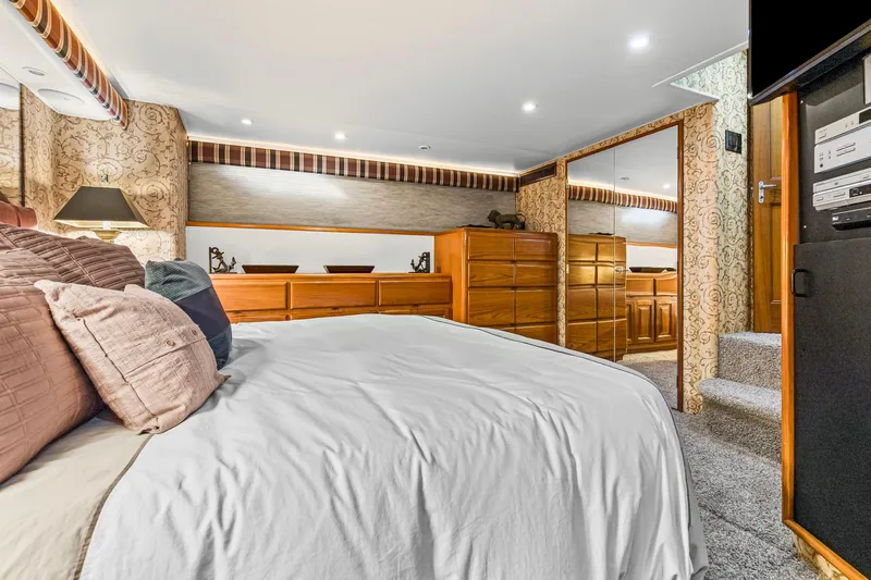  Yacht Photos Pics Luxurious bedroom interior of 1998 Viking 72 Enclosed Bridge yacht with elegant decor.